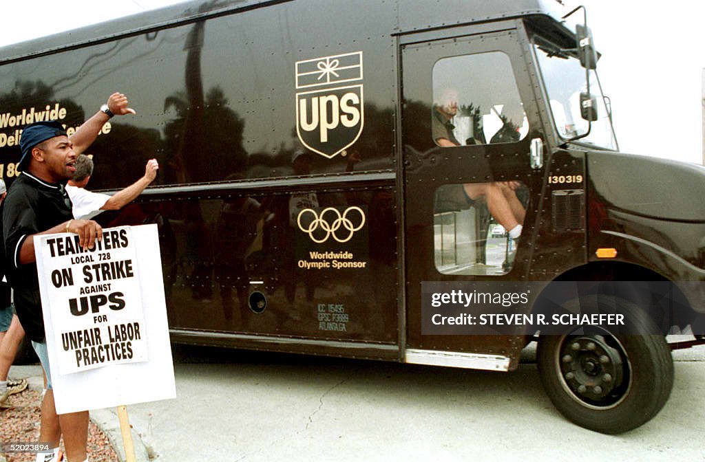 United Parcel Services truck driver Rick Moore (L)