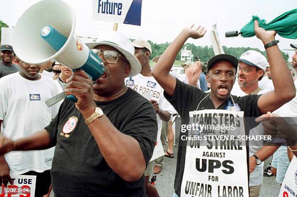 Big C. Mason and Jeff Smith rally the the estimated 5,000 picketers and Teamsters supporters at a unity rally near the Norcross, GA, UPS hub 14...