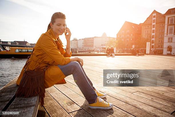 frau mit smartphone in der stadt. - kommunikationskanäle stock-fotos und bilder