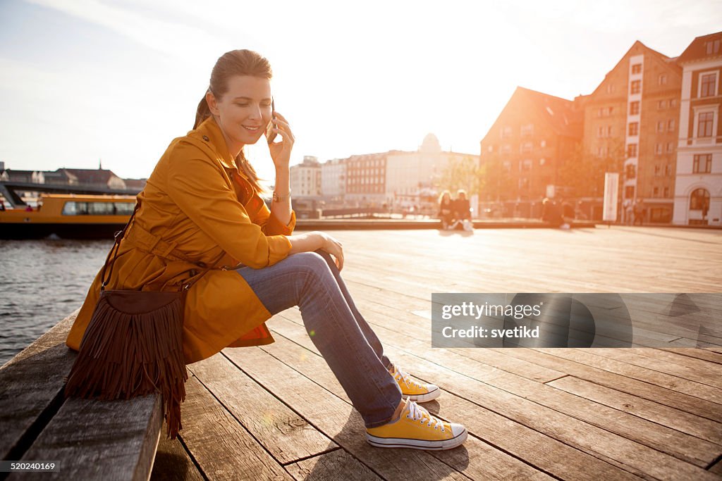 Woman in city using smart phone.