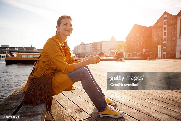 woman in city enjoyng sun. - copenhagen stock pictures, royalty-free photos & images