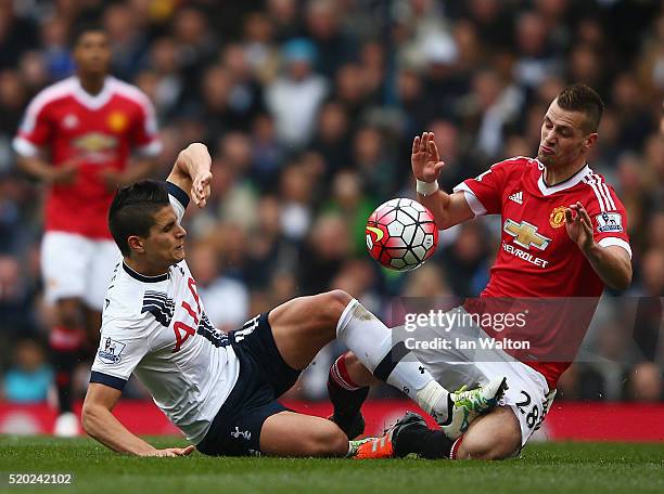 Erik Lamela of Tottenham Hotspur and Morgan Schneiderlin of Manchester United battle for ball during the Barclays Premier League match between...