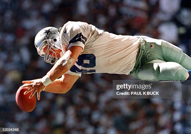 Dallas Cowboy fullback Daryl "Moose" Johnston grabs a pass from Troy Aikman good for a first down against the Chicago Bears at Texas Stadium in...