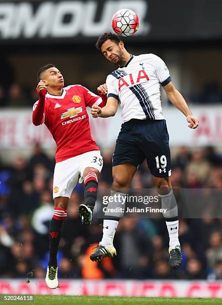 Jesse Lingard of Manchester United and Mousa Dembele of Tottenham Hotspur jump for the ball during the Barclays Premier League match between...