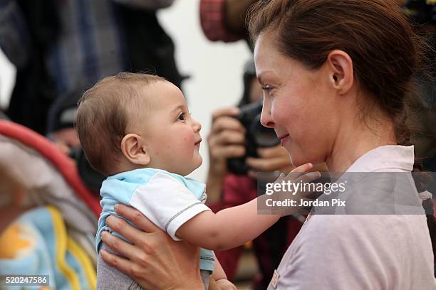Goodwill ambassador for the United Nations Population Fund and actress Ashley Judd interacts with a Syrian refugee child during her visit to the...