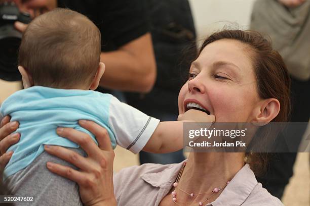 Goodwill ambassador for the United Nations Population Fund and actress Ashley Judd interacts with a Syrian refugee child during her visit to the...