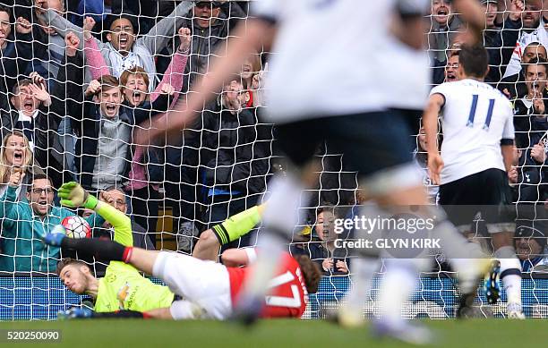 Tottenham Hotspur's Argentinian midfielder Erik Lamela scores past Manchester United's Spanish goalkeeper David de Gea during the English Premier...