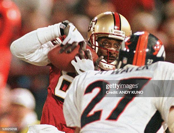 San Francisco 49'ers wide-receiver Jerry Rice hauls in a catch for his first touchdown catch as Denver Broncos safety Steve Atwater tries to defend...