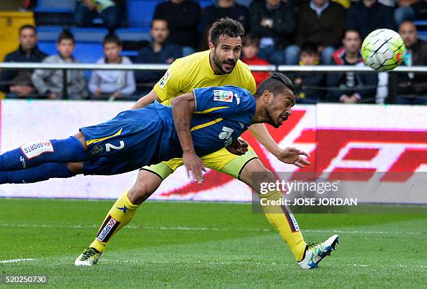 Getafe's defender Alovaro Pereira heads the ball past Villarreal's defender Mario during the Spanish league football match Villarreal CF vs Getafe CF...