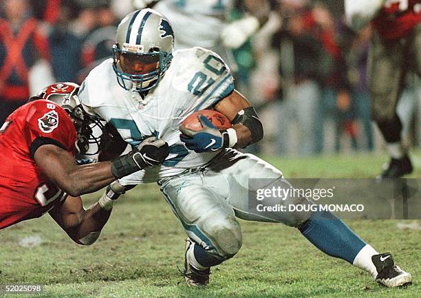 Detroit Lions running back Barry Sanders is stopped by Derrick Brooks of the Tampa Bay Buccaneers 28 December during their NFC Wild Card playoff game...