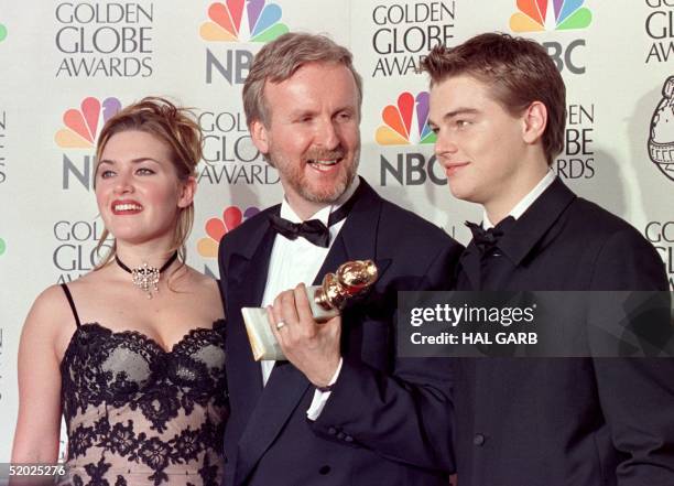 Director James Cameron and actress Kate Winslet and actor Leonardo DiCaprio pose for photographers after Cameron won the award for Best Director for...