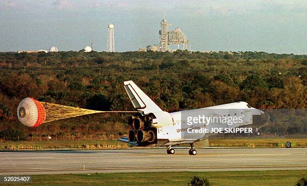The Space Shuttle orbiter Endeavour uses a parachute to slow down as it makes its way down runway 115 at the Kennedy Space Center 31 January after it...