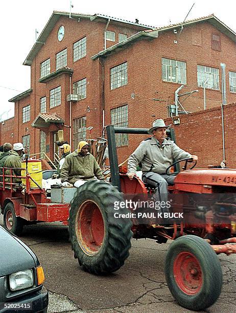 Texas Department of Corrections officer drives a tractor carrying inmates before the Huntsville Unit 02 February in Huntsville, Texas. The Texas...