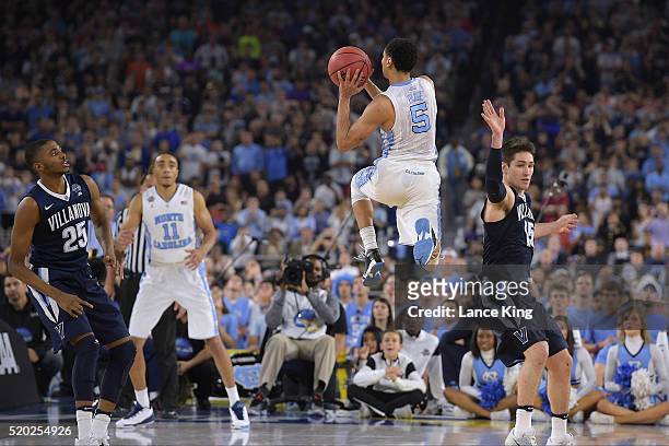 Marcus Paige of the North Carolina Tar Heels puts up a three-point shot to tie the score at 74-74 with 4.7 seconds left in the game against the...