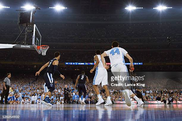 Marcus Paige of the North Carolina Tar Heels puts up a three-point shot to tie the score at 74-74 with 4.7 seconds left in the game against the...
