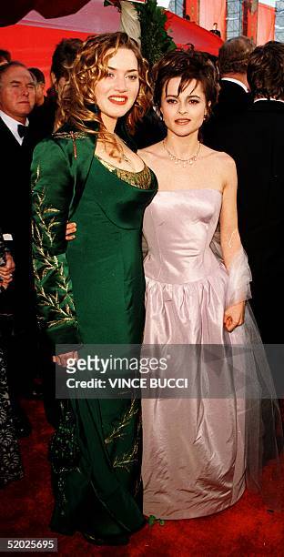 Best Actress nominees Kate Winslet for "Titanic" and Helena Bonham Carter for "Wings Of The Dove", arrive at the 70th Annual Academy Awards ceremony...