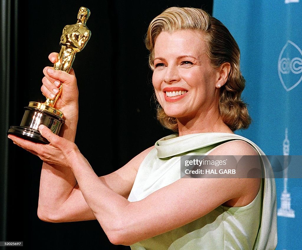 Actress Kim Basinger holds up her Oscar for Best S
