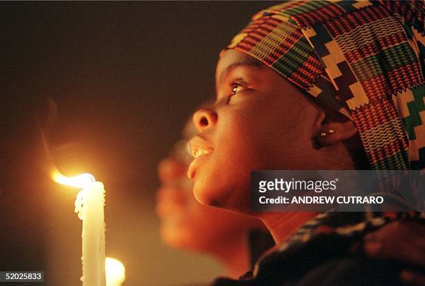 Latiffany Strickland holds a candle, 04 April in Memphis, TN, as she participates in a vigil for the late Martin Luther King, Jr. At the National...