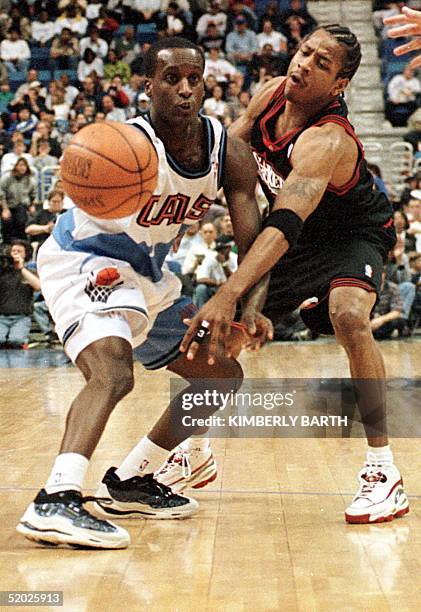 Philadelphia 76'ers guard Allen Iverson applies pressure to Cleveland Cavaliers guard Brevin Knight as he attempts to pass the ball in the first half...