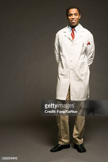 male physician on black background, portrait - doctor full length stock pictures, royalty-free photos & images