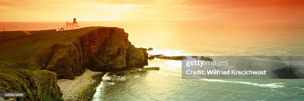 Coast with the lighthouse Stoer Head at sunset (Scotland)