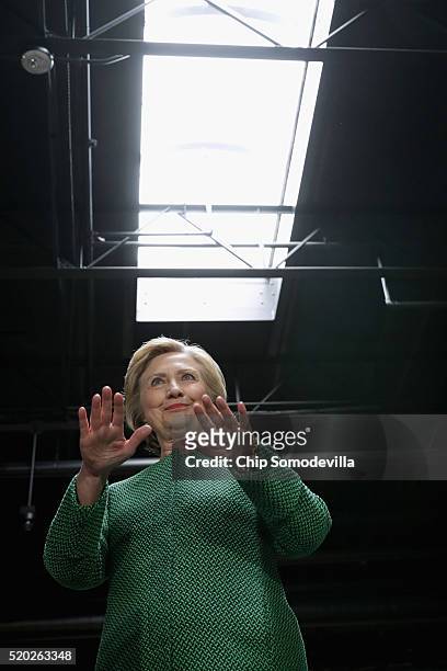 Democratic presidential candidate Hillary Clinton gestures for guests to quiet down as she is introduced during a campaign rally at City Garage April...