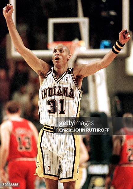 Reggie Miller of the Indiana Pacers reacts after making a basket against the Chicago Bulls 23 May during the second half of game three of their NBA...