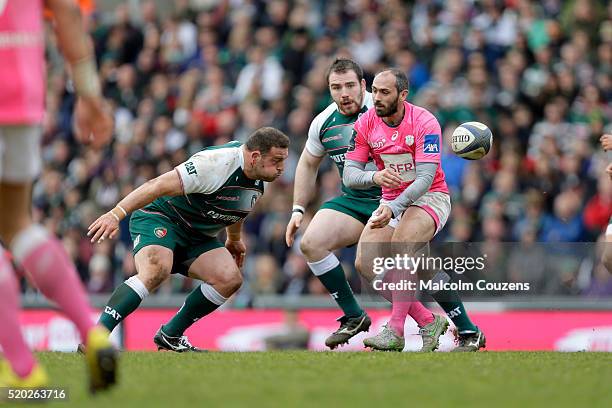 Julien Dupuy of Stade Francais gets a pass away under pressure from Greg Bateman of Leicester Tigers during the European Rugby Champions Cup Quarter...