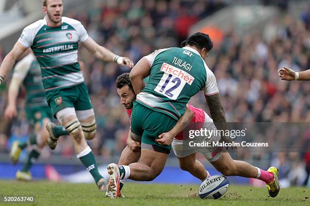 Jeremy Sinzelle of Stade Francais tackles Manu Tuilagi of Leicester Tigers during the European Rugby Champions Cup Quarter Final between Leicester...