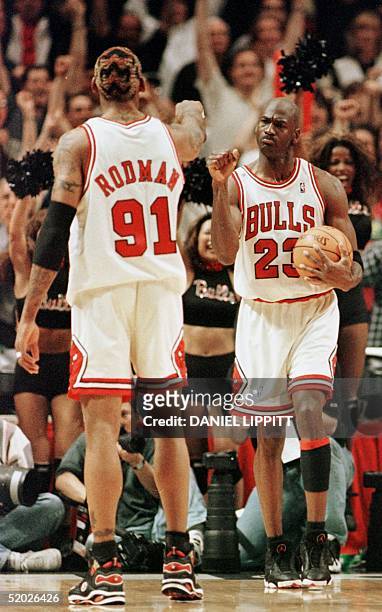 Michael Jordan of the Chicago Bulls celebrates with teammate Dennis Rodman after winning game seven of the NBA Eastern Conference finals against the...