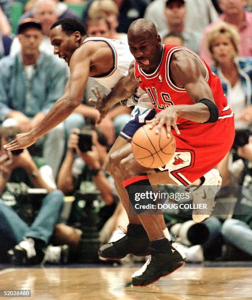 Michael Jordan of the Chicago Bulls steals the ball from Shandon Anderson of the Utah Jazz 05 June during first half action of game two of the NBA...