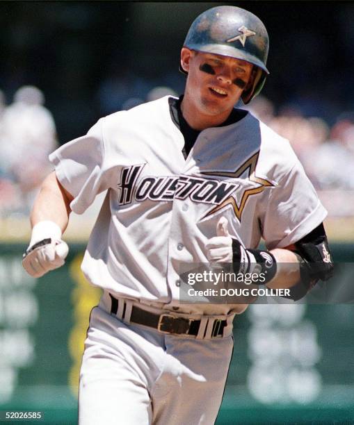 Houston Astros player Craig Biggio rounds third base after the ball he hit deep to center field bounced off the wall and was ruled a homerun during...