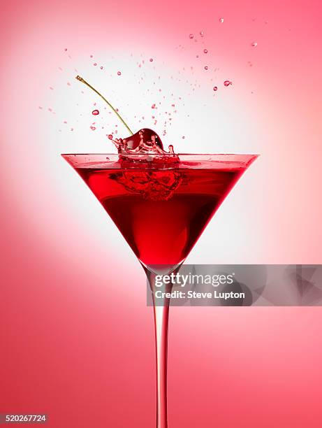 cherry splashing into juice - splashing cocktail stock pictures, royalty-free photos & images