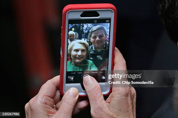 Democratic presidential candidate Hillary Clinton takes a supports phone and snaps a selfie at the conclusion of a campaign rally at City Garage...