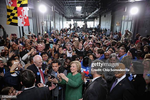 Democratic presidential candidate Hillary Clinton takes a selfie with a supporter during a campaign rally at City Garage April 10, 2016 in Baltimore,...