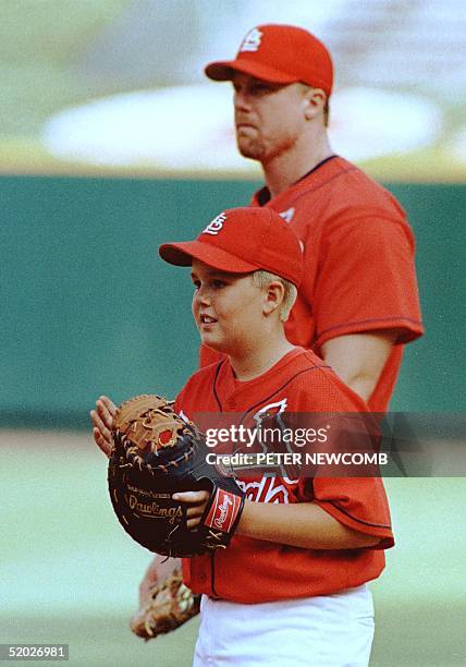 St. Louis Cardinal Mark McGwire appears with his 10-year-old son Matt McGwire during a pre-game warm-up before the Cardinal's game against the...