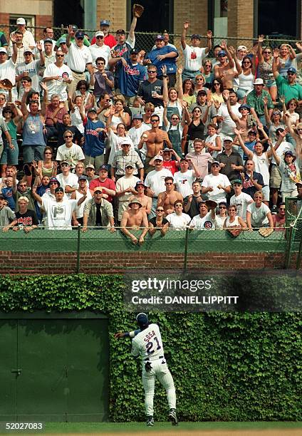 This 02 September 1998 file photo shows Chicago Cubs outfielder Sammy Sosa tossing a ball to the fans in the rightfield bleachers during the Cubs'...