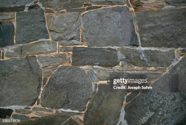stone wall - schist stock-fotos und bilder