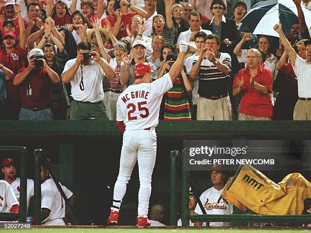 St. Louis Cardinals first baseman Mark McGwire waves to the crowd at Busch Stadium in St. Louis, MO after hitting his 63rd home run while pinch...
