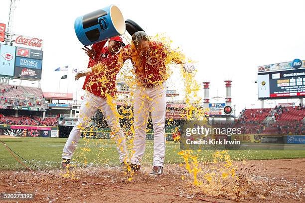 Jay Bruce of the Cincinnati Reds has a bucket of Powerade poured over him after hitting a walk-off triple to defeat the Pittsburgh Pirates 2-1 at...