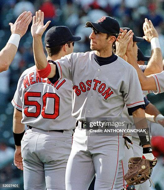 Boston Red Sox shortstop Nomar Garciaparra is congratulated as he walks through the line after the Red Sox defeated the Cleveland Indians in game one...