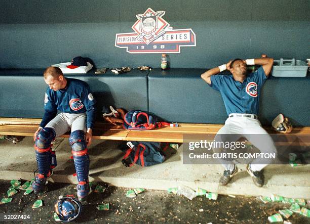 Chicago Cubs Scott Servais and Manny Alexander sit dejected in the Cubs dugout after losing their second divisional playoff game in the 10th inning...