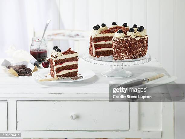 homemade black forest gateau with a slice on a plate - black forest gateau stock-fotos und bilder