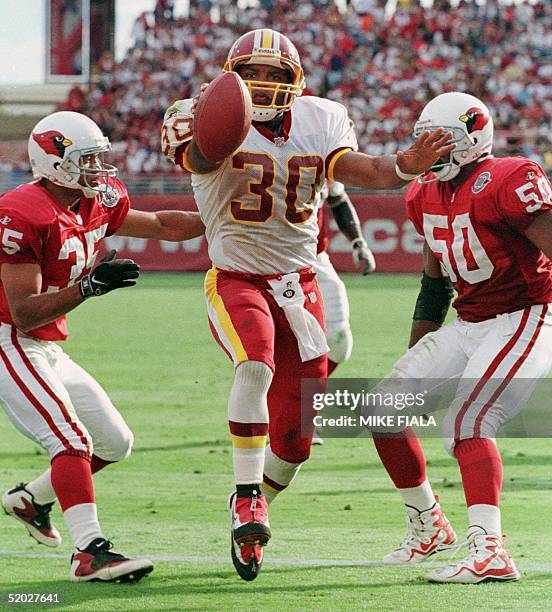 Washington Redskins' runningback Brian Mitchell scores his team's second touchdown between Arizona Cardinals' safety Aeneas Williams and linebacker...