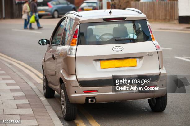 an m.go microcar parked on double yellow lines, in loughborough, leicestershire, uk - linea gialla foto e immagini stock