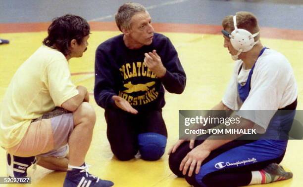 This May 1992 photo shows John DuPont, , talking with wrestlers at Foxcatcher, an Olympic training facility he operates on his 800-acre estate in...