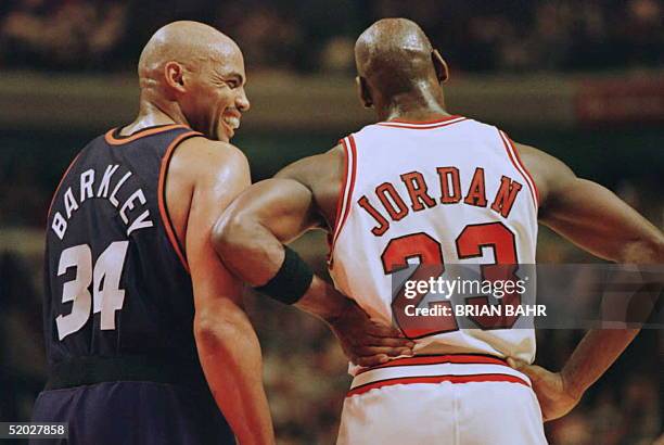 Phoenix Suns forward Charles Barkley laughs at a foul call with Chicago Bulls guard Michael Jordan in the first half 28 January 1996 at the United...