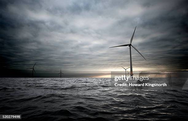 wind farm in the thames estuary - storm clouds stock pictures, royalty-free photos & images