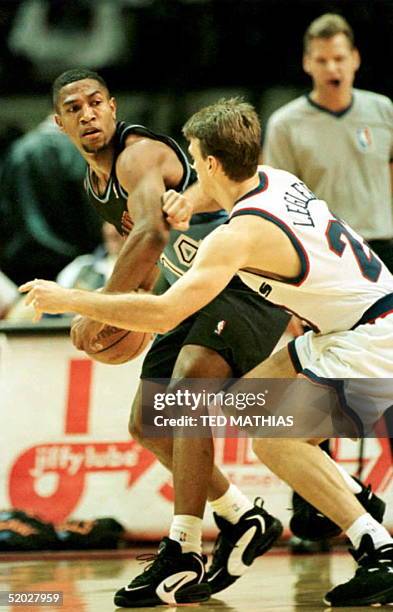 Cleveland Cavalier Bobby Phills sizes up Washington Bullet Tim Legler before driving to the basket in the third quarter in Landover, Md., 02 January....