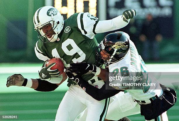 New York Jets wide receiver Keyshawn Johnson is tackled by Jacksonville Jaguars defender Kevin Devine after a pass reception in the second quarter of...
